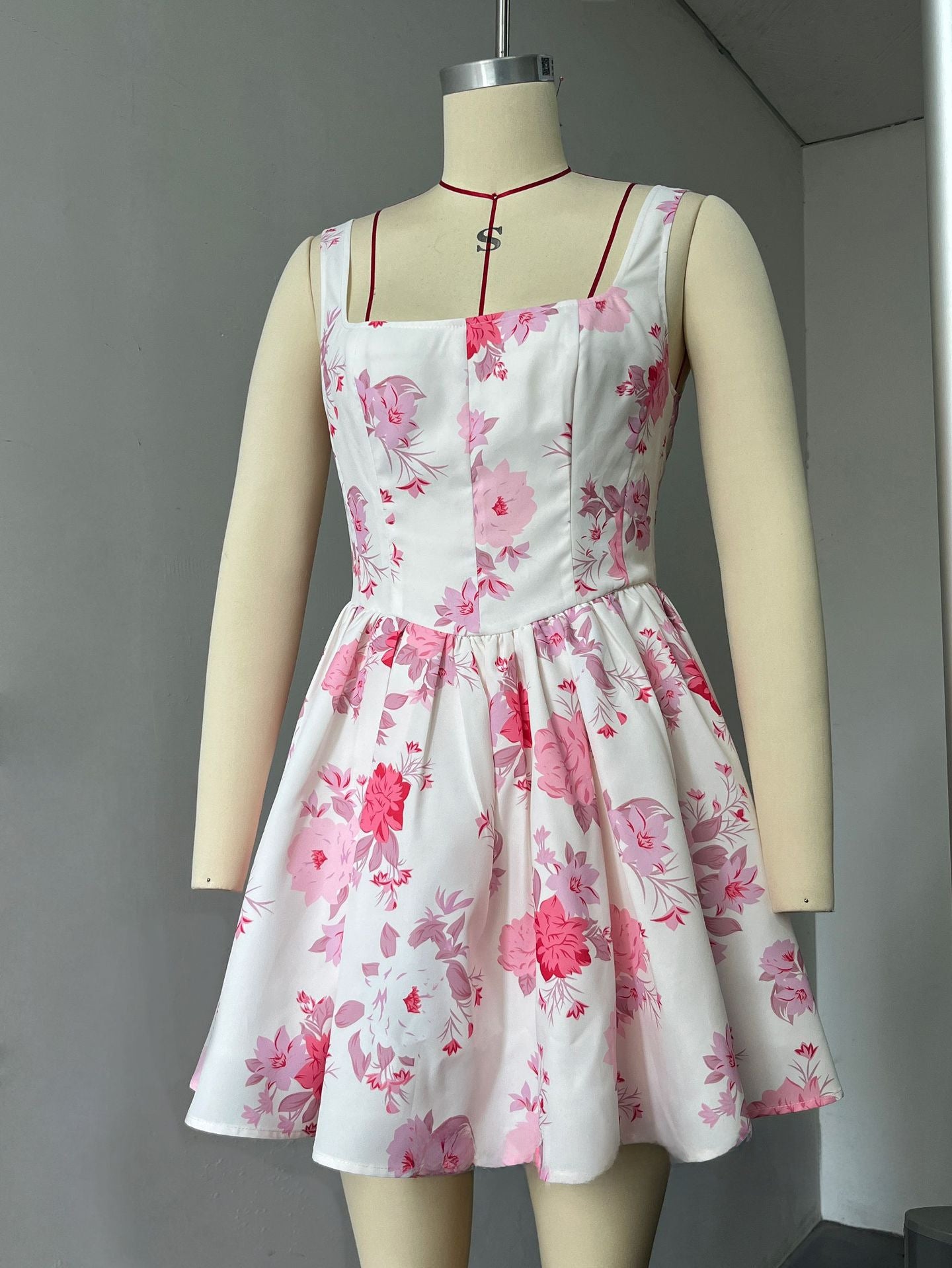 A cinched waist halter dress with floral rose prints