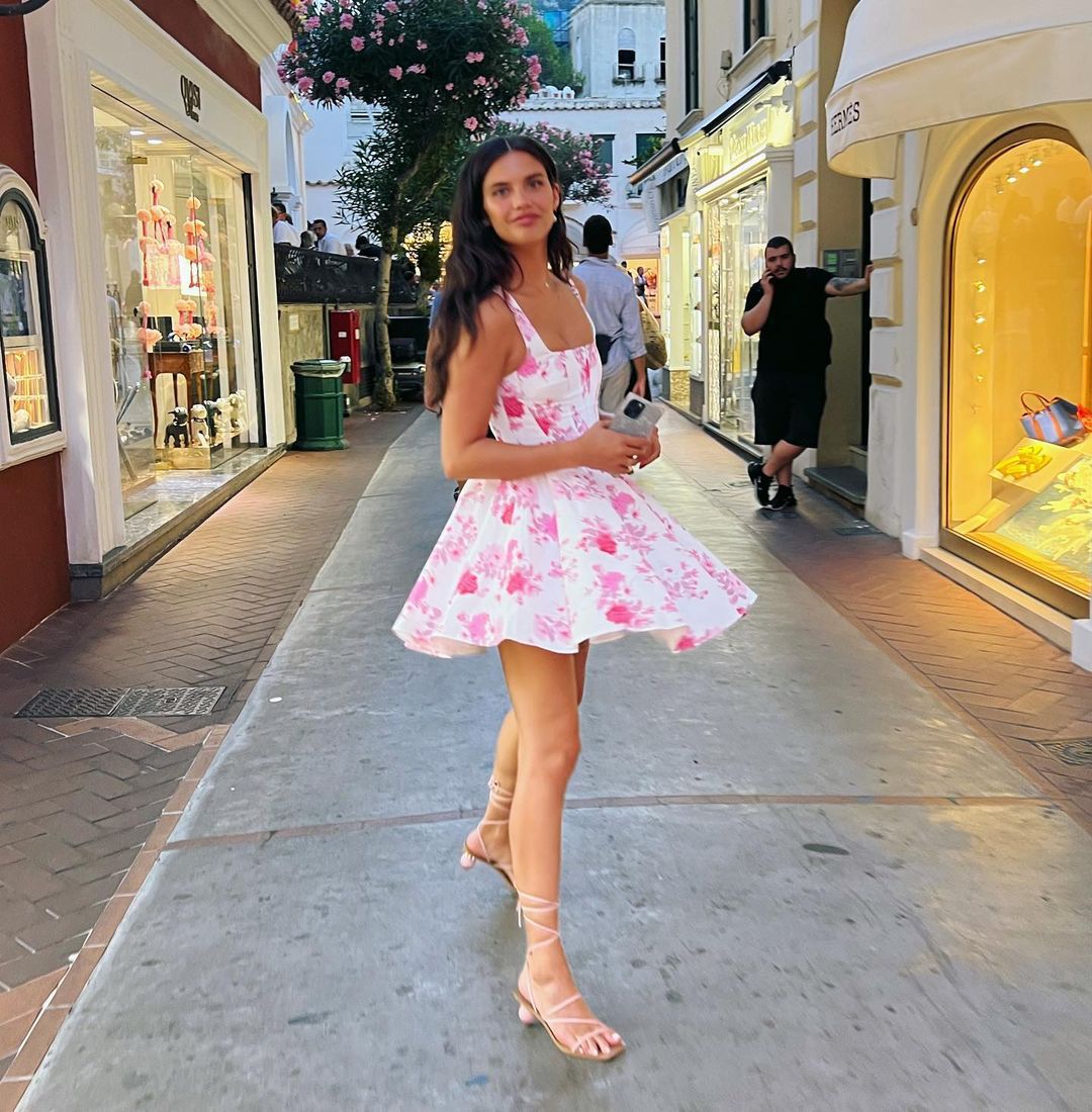 A cinched waist halter dress with floral rose prints