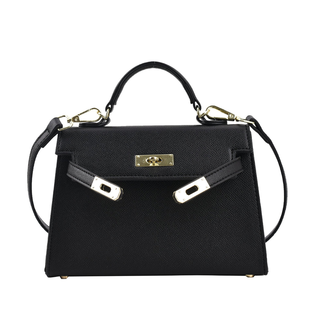 A woman carrying a small square bag with a lock